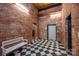 Lobby with brick walls, checkerboard floor and bench at 201 S Hoskins Rd # 313, Charlotte, NC 28208