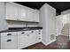 Basement kitchenette with white cabinets and dark countertop at 204 Swamp Fox Dr, Fort Mill, SC 29715