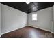 Simple basement bedroom with dark ceiling and wood floors at 204 Swamp Fox Dr, Fort Mill, SC 29715