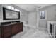 Clean bathroom with dark vanity, bathtub and tile flooring at 204 Swamp Fox Dr, Fort Mill, SC 29715