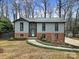 Charming ranch home with brick and gray siding, landscaped yard, and walkway at 204 Swamp Fox Dr, Fort Mill, SC 29715