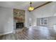 Living room with stone fireplace and hardwood floors at 204 Swamp Fox Dr, Fort Mill, SC 29715