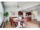 Open concept dining area featuring a wooden table with bench seating and seamlessly flowing into a modern kitchen at 2065 Taney Way, Fort Mill, SC 29707