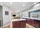 Open kitchen and dining room area with modern lighting, white countertops, stainless appliances, and lots of natural light at 2065 Taney Way, Fort Mill, SC 29707