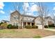 Charming two-story home featuring a welcoming front porch and well-maintained landscaping with mature trees at 2065 Taney Way, Fort Mill, SC 29707