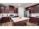 Modern kitchen with stainless steel appliances, a large island and dark wood cabinetry at 2065 Taney Way, Fort Mill, SC 29707