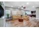 Cozy living room with a large sofa, ceiling fan, wood floors, and lots of natural light at 2065 Taney Way, Fort Mill, SC 29707