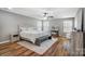 Main bedroom with hardwood floors, neutral paint, a ceiling fan, and lots of natural light at 2065 Taney Way, Fort Mill, SC 29707