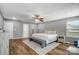 Main bedroom with hardwood floors, neutral paint, a ceiling fan, and lots of natural light at 2065 Taney Way, Fort Mill, SC 29707