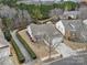 Aerial view of a well maintained home and property showcasing professional landscaping and an attached two car garage at 23234 Kingfisher Dr, Indian Land, SC 29707