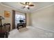 Bright bedroom with a large window, work desk, and neutral color scheme at 23234 Kingfisher Dr, Indian Land, SC 29707