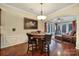 Cozy breakfast nook features a round wood table and views into the window-filled sunroom at 23234 Kingfisher Dr, Indian Land, SC 29707