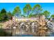 Community entrance sign with a stone waterfall feature and lush landscaping at 23234 Kingfisher Dr, Indian Land, SC 29707