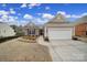 Charming single-Gathering home features stone accents, a two-car garage, and a well-manicured lawn, creating a welcoming curb appeal at 23234 Kingfisher Dr, Indian Land, SC 29707