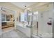 Relaxing main bathroom featuring a jetted tub and glass shower at 23234 Kingfisher Dr, Indian Land, SC 29707