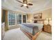 Spacious main bedroom with large windows, tray ceiling, and natural wood furniture at 23234 Kingfisher Dr, Indian Land, SC 29707