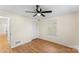 A bright bedroom offers a ceiling fan and natural light from a window and wood floors at 2357 13Th Street Ne Dr, Hickory, NC 28601