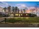 Charming single-story brick home boasting a spacious front yard and beautiful sunset skies at 2357 13Th Street Ne Dr, Hickory, NC 28601