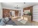 Inviting living room featuring exposed brick wall, hardwood floors, and modern decor at 2357 13Th Street Ne Dr, Hickory, NC 28601