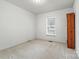 Simple bedroom with carpeted floor and large window at 2363 24Th Street Ne Ln, Hickory, NC 28601