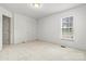 Simple bedroom with carpet, window, and neutral color walls at 2363 24Th Street Ne Ln, Hickory, NC 28601