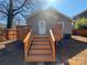 Backyard view featuring a new deck with stairs, siding, privacy fence, and landscaping, creating a private outdoor oasis at 238 Coxe Ave, Charlotte, NC 28208