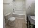 Bright bathroom features a shower-tub combo, granite vanity and ceramic tile flooring at 238 Coxe Ave, Charlotte, NC 28208