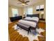 Well lit bedroom with modern furnishings featuring ceiling fan and hardwood floors at 238 Coxe Ave, Charlotte, NC 28208