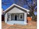 Inviting gray home with black door, white trim, and covered front porch at 238 Coxe Ave, Charlotte, NC 28208