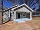 Charming gray home with black door, white trim, and inviting covered front porch at 238 Coxe Ave, Charlotte, NC 28208