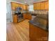 Updated kitchen featuring wooden cabinets, granite counters, and stainless steel appliances at 238 Coxe Ave, Charlotte, NC 28208