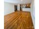 Open-concept living room flows into a kitchen with stainless steel appliances and warm wood cabinets at 238 Coxe Ave, Charlotte, NC 28208