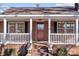 Inviting front porch with white railings and red door at 2614 S Us 321 Hwy, Newton, NC 28658