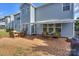 Spacious brick patio features outdoor seating and a retractable awning, creating a relaxing backyard entertaining space at 265 Sutro Forest Nw Dr, Concord, NC 28027