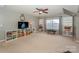 Bright bonus room with large TV, shelving, and a window offers plenty of space for recreation and storage at 265 Sutro Forest Nw Dr, Concord, NC 28027