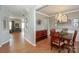 Open-concept dining room with wood floors, chandelier, and access to multiple rooms at 265 Sutro Forest Nw Dr, Concord, NC 28027