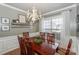 Bright dining room featuring a chandelier, decorative shelf, and a large window with natural light at 265 Sutro Forest Nw Dr, Concord, NC 28027