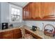 Cozy home office features granite countertops, patterned backsplash, and ample cabinet space at 265 Sutro Forest Nw Dr, Concord, NC 28027