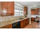 Kitchen features granite countertops, wood cabinets and stainless steel sink near the window at 265 Sutro Forest Nw Dr, Concord, NC 28027