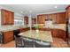 Spacious kitchen featuring granite countertops, an island with barstools, and a sink under the window at 265 Sutro Forest Nw Dr, Concord, NC 28027