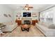 Bright living room featuring a cozy fireplace, built-in shelves, and a comfortable seating arrangement at 265 Sutro Forest Nw Dr, Concord, NC 28027