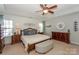 Spacious main bedroom with tray ceiling, ceiling fan, and windows providing natural light at 265 Sutro Forest Nw Dr, Concord, NC 28027