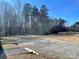 Backyard with tall trees and gravel driveway at 2704 Kool Park Ne Rd, Hickory, NC 28601