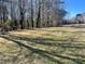 Backyard with tall trees and grassy area at 2704 Kool Park Ne Rd, Hickory, NC 28601