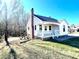 White house with a porch, brick chimney, and landscaping at 2704 Kool Park Ne Rd, Hickory, NC 28601