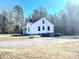 White house with a gravel driveway and surrounding trees at 2704 Kool Park Ne Rd, Hickory, NC 28601