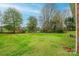 Spacious backyard with lush green grass and mature trees at 2752 21St Ne St, Hickory, NC 28601