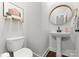 Stylish bathroom with pedestal sink, round mirror, and modern fixtures at 305 Ideal Way, Charlotte, NC 28203