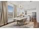 Bright dining area with a white table and gold chairs, adjacent to the kitchen at 305 Ideal Way, Charlotte, NC 28203