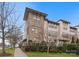 Brick three-story townhome with sidewalk and landscaping at 305 Ideal Way, Charlotte, NC 28203